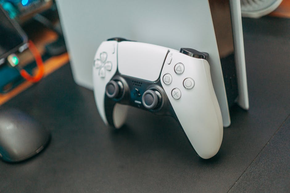 Close-up of a PlayStation 5 controller resting on its console, showcasing modern gaming technology.